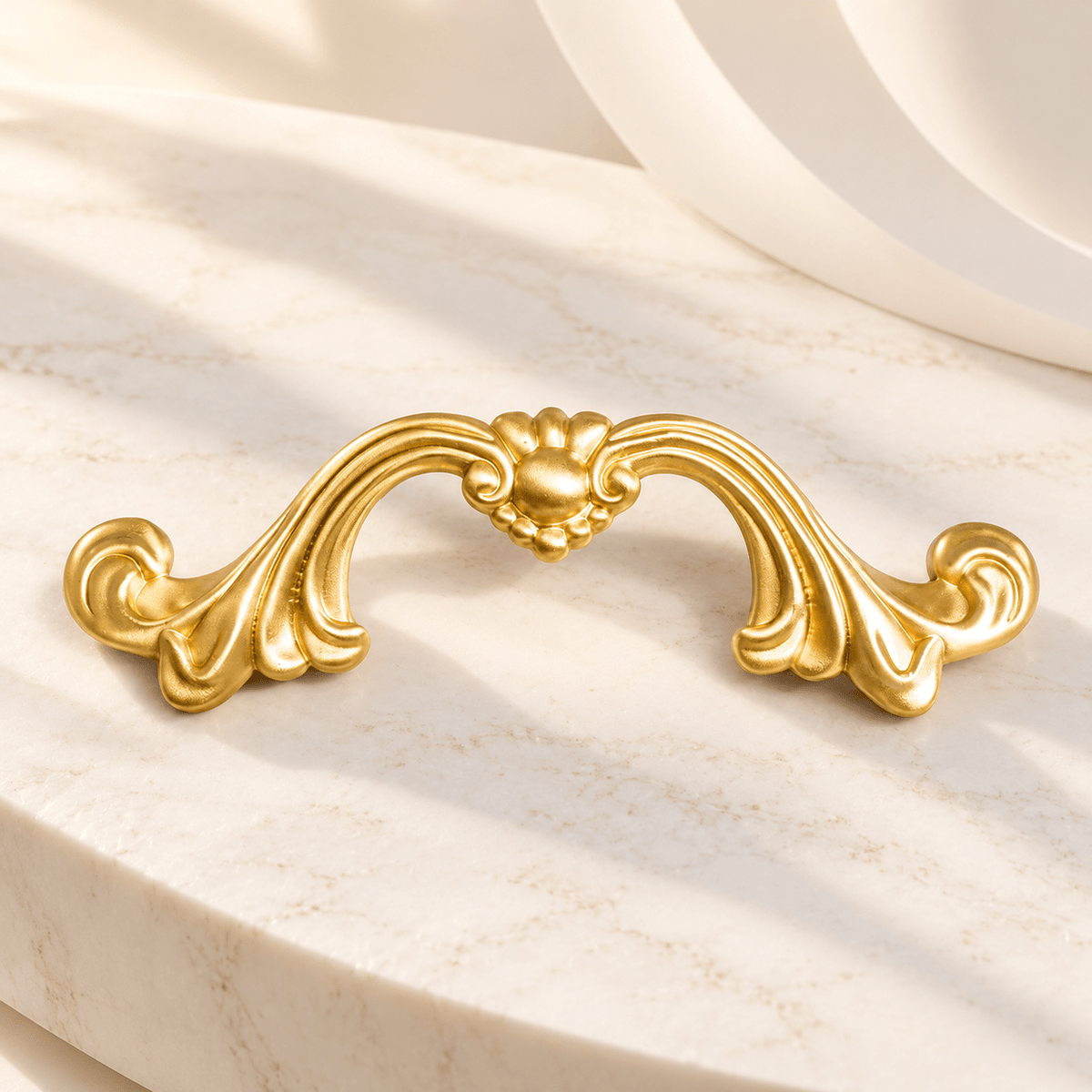 Ornate gold cabinet pull with floral scrollwork and 96 mm hole spacing on white stone