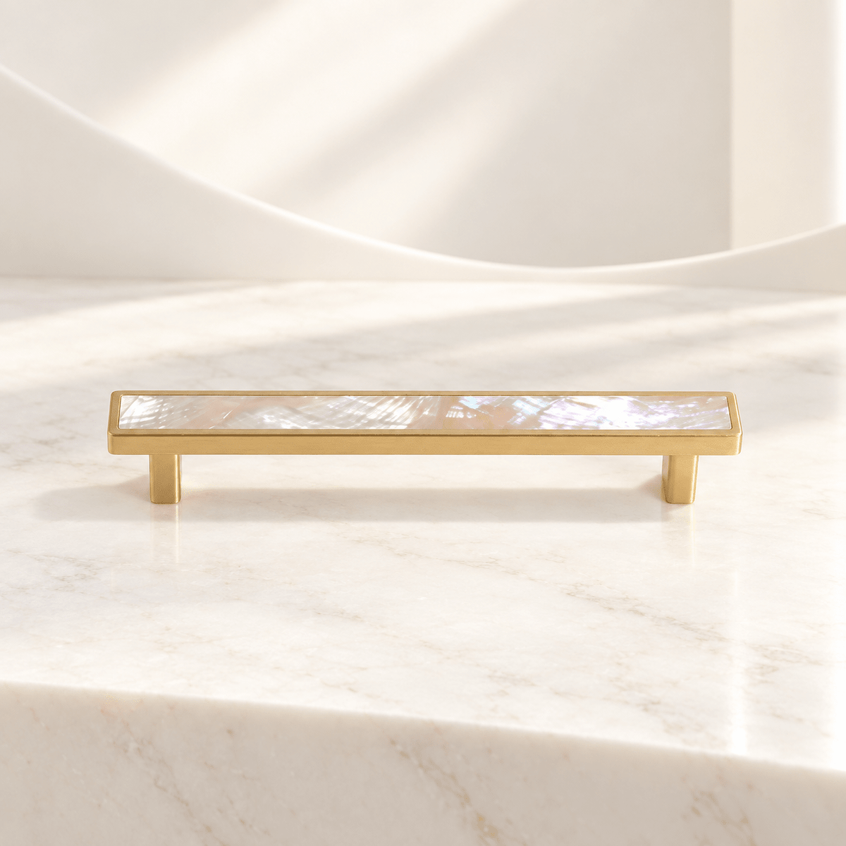 Pink shell cabinet pull with 128 mm (5.04 in) hole spacing on ivory stone