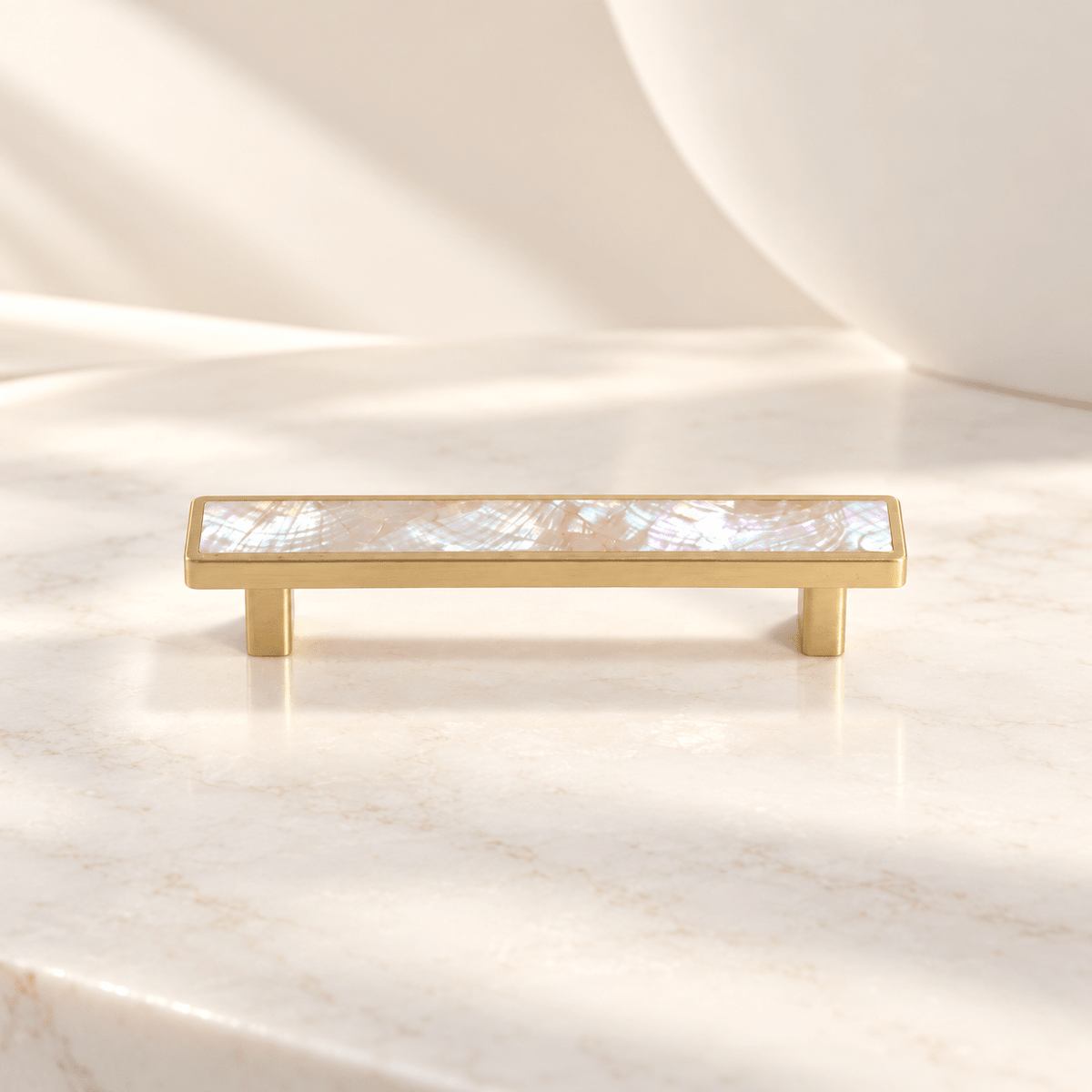 Pink shell cabinet pull with 96 mm (3.78 in) hole spacing on ivory stone