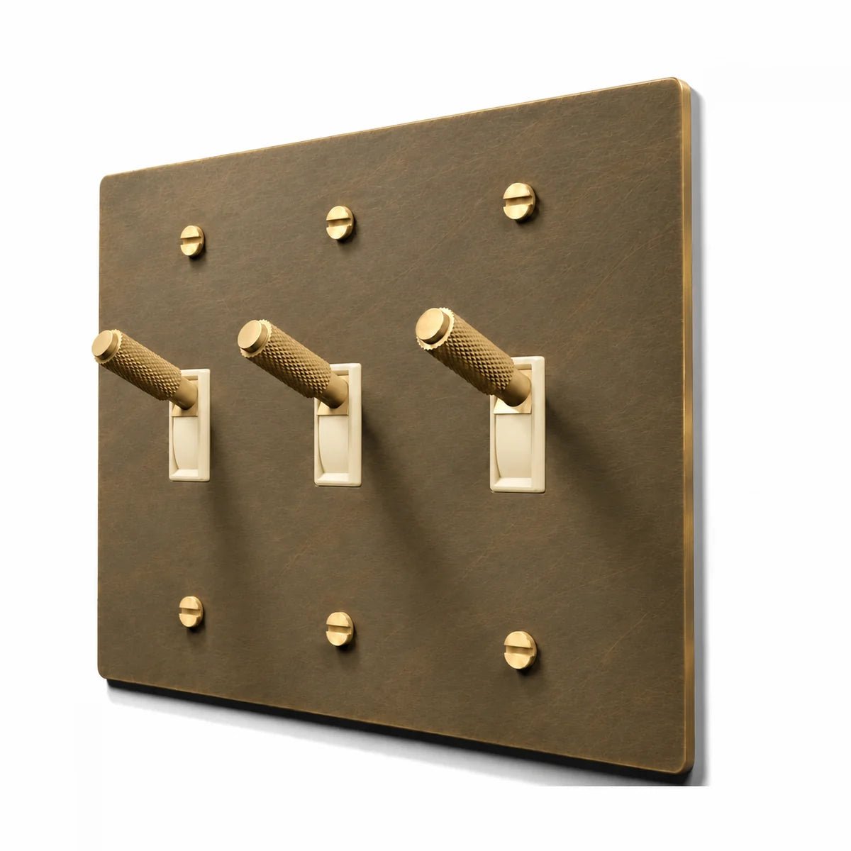 PlatePrestige Brass Toggle Switch 3-Gang in Aged Brass with ivory toggle frames, angled view
