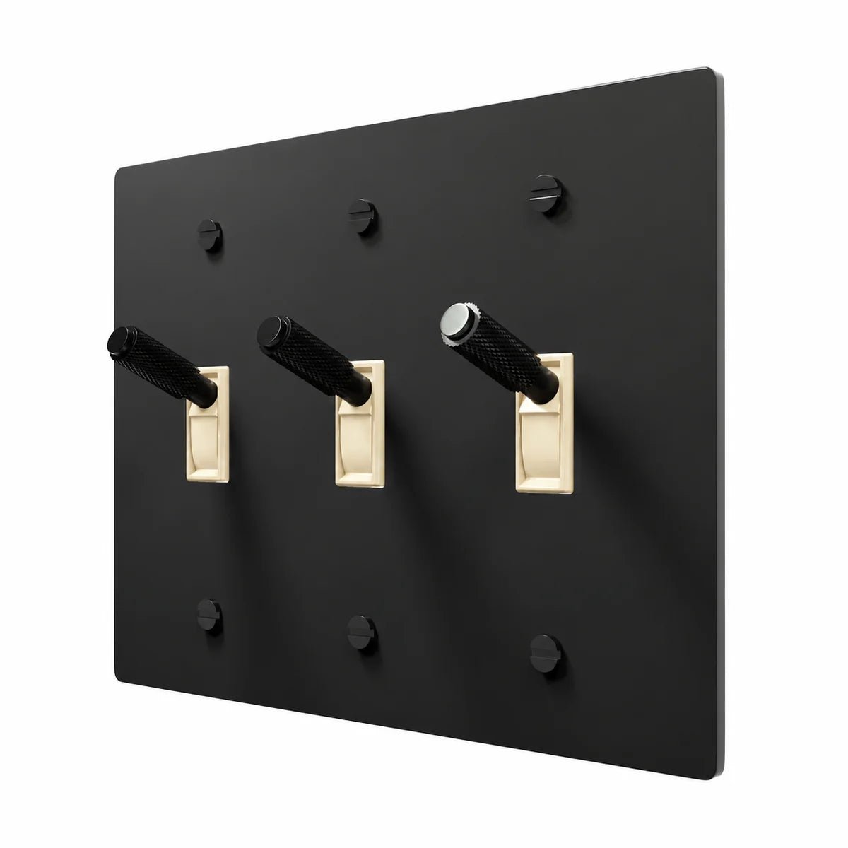 PlatePrestige Brass Toggle Switch 3-Gang in All‑Black with ivory toggle frames, angled view