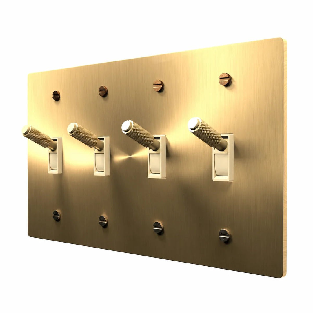 PlatePrestige Brass Toggle Switch 4-Gang in Brass with ivory toggle frames, angled view