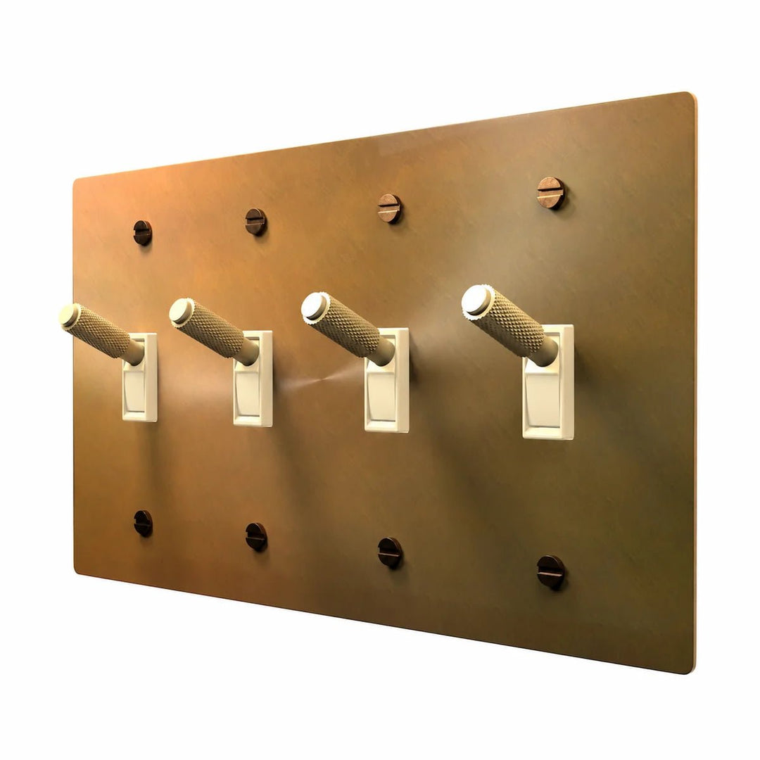 PlatePrestige Brass Toggle Switch 4-Gang in Unlacquered Aged brass with ivory toggle frames, angled view
