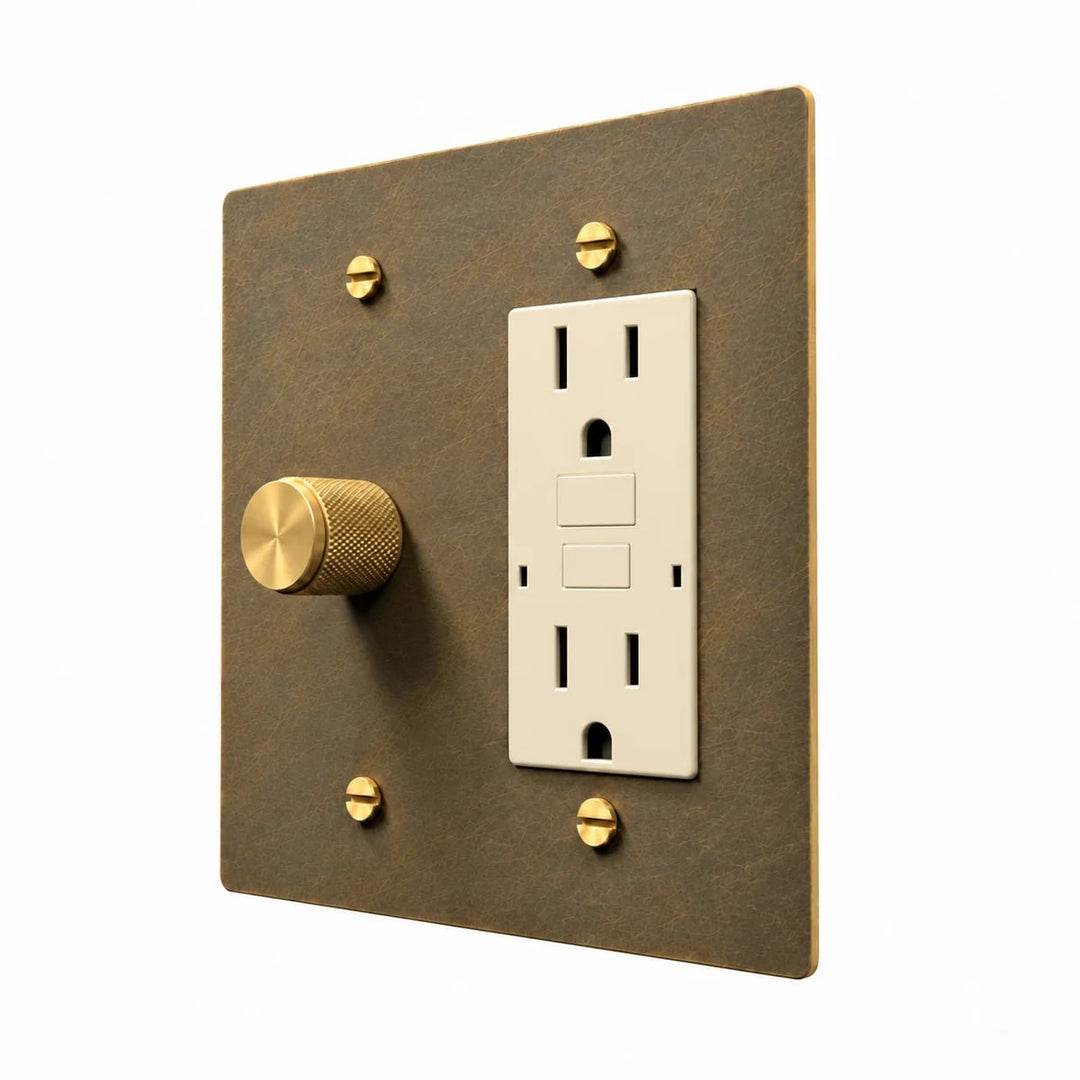 Brass Dimmer & Outlet Combo Switch Plate in Aged Brass with ivory outlet inserts, angled view
