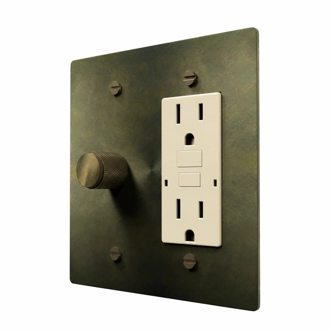 Brass Dimmer & Outlet Combo Switch Plate in Antique Brass with ivory outlet inserts, angled view