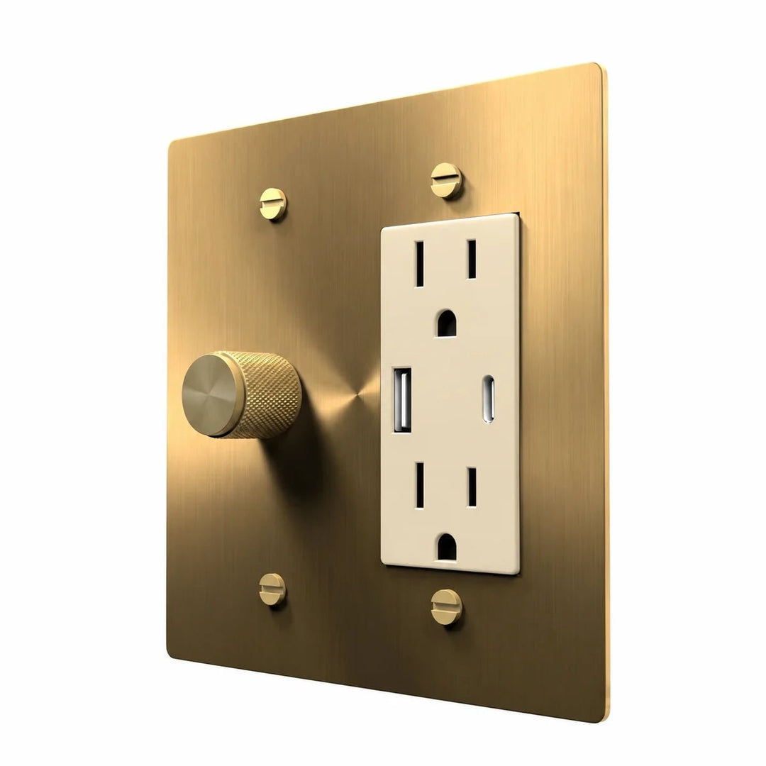 Brass Dimmer & Outlet Combo Switch Plate in Brass with ivory outlet inserts, angled view