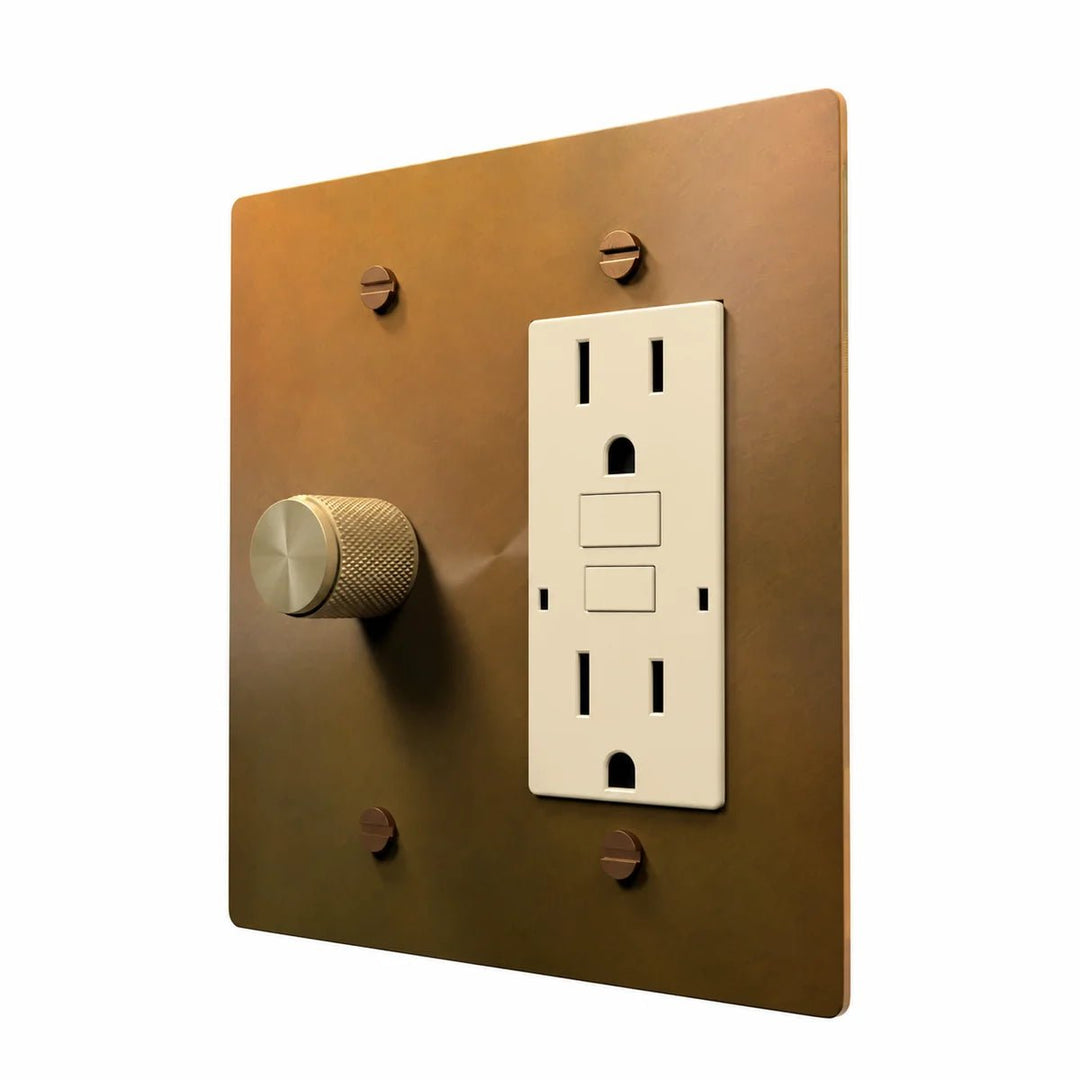 Brass Dimmer & Outlet Combo Switch Plate in Unlacquered Aged brass with ivory outlet inserts, angled view