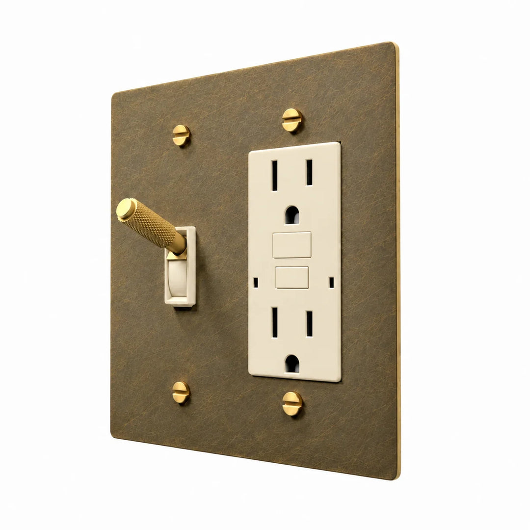 Brass Toggle & Outlet Combo Switch Plate in Aged Brass with ivory toggle frames and outlet inserts, angled view