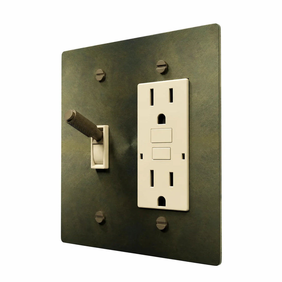 Brass Toggle & Outlet Combo Switch Plate in Antique Brass with ivory toggle frames and outlet inserts, angled view