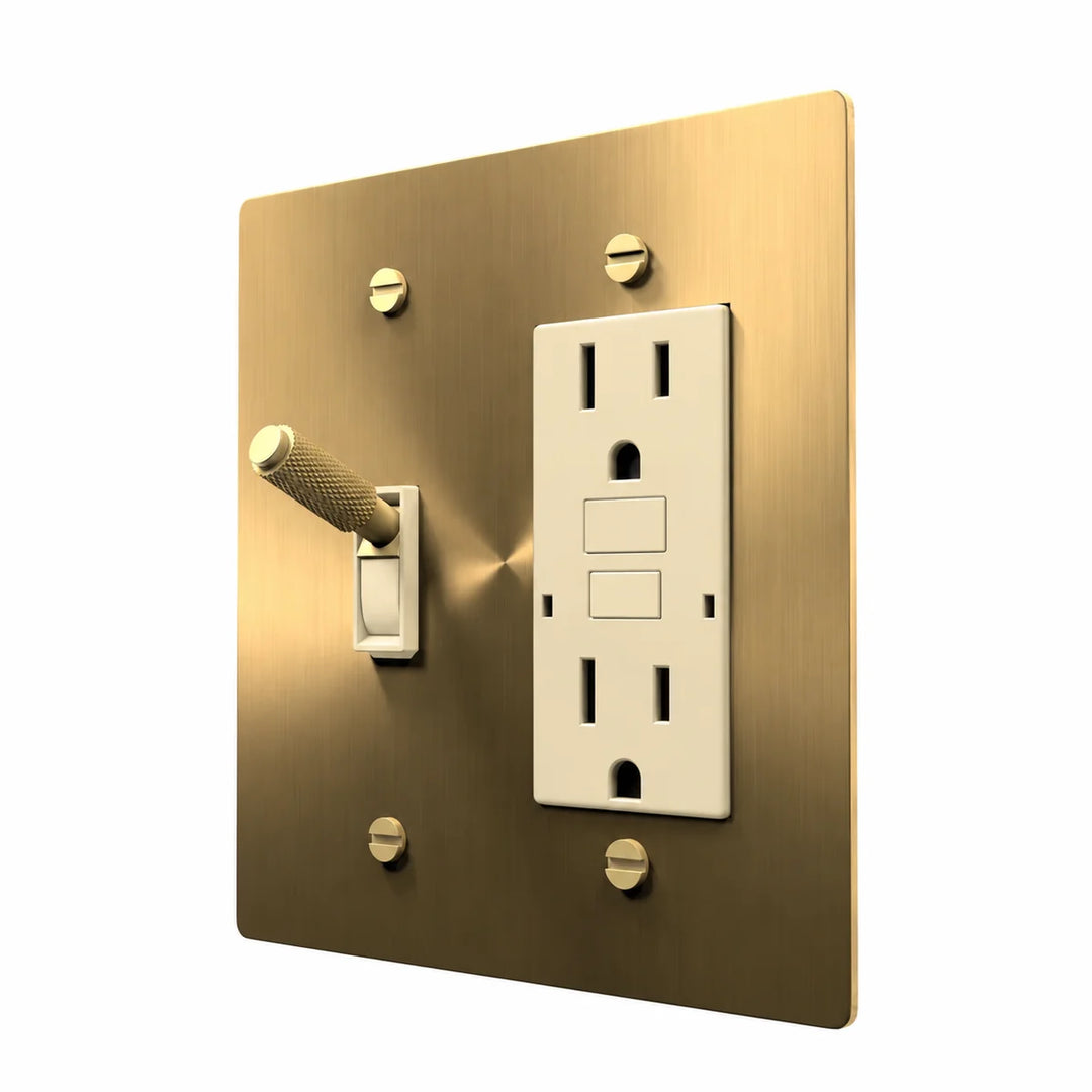 Brass Toggle & Outlet Combo Switch Plate in Brass with ivory toggle frames and outlet inserts, angled view