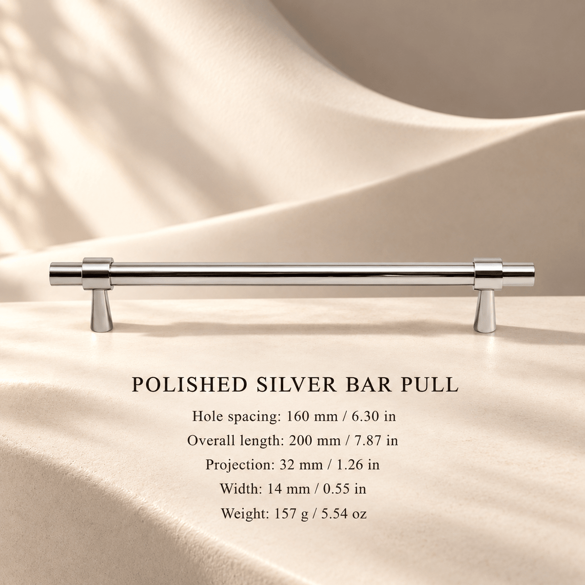 Polished silver solid brass cabinet pull, 160 mm hole spacing, with individual millimeter and inch measurements in an ivory stone studio