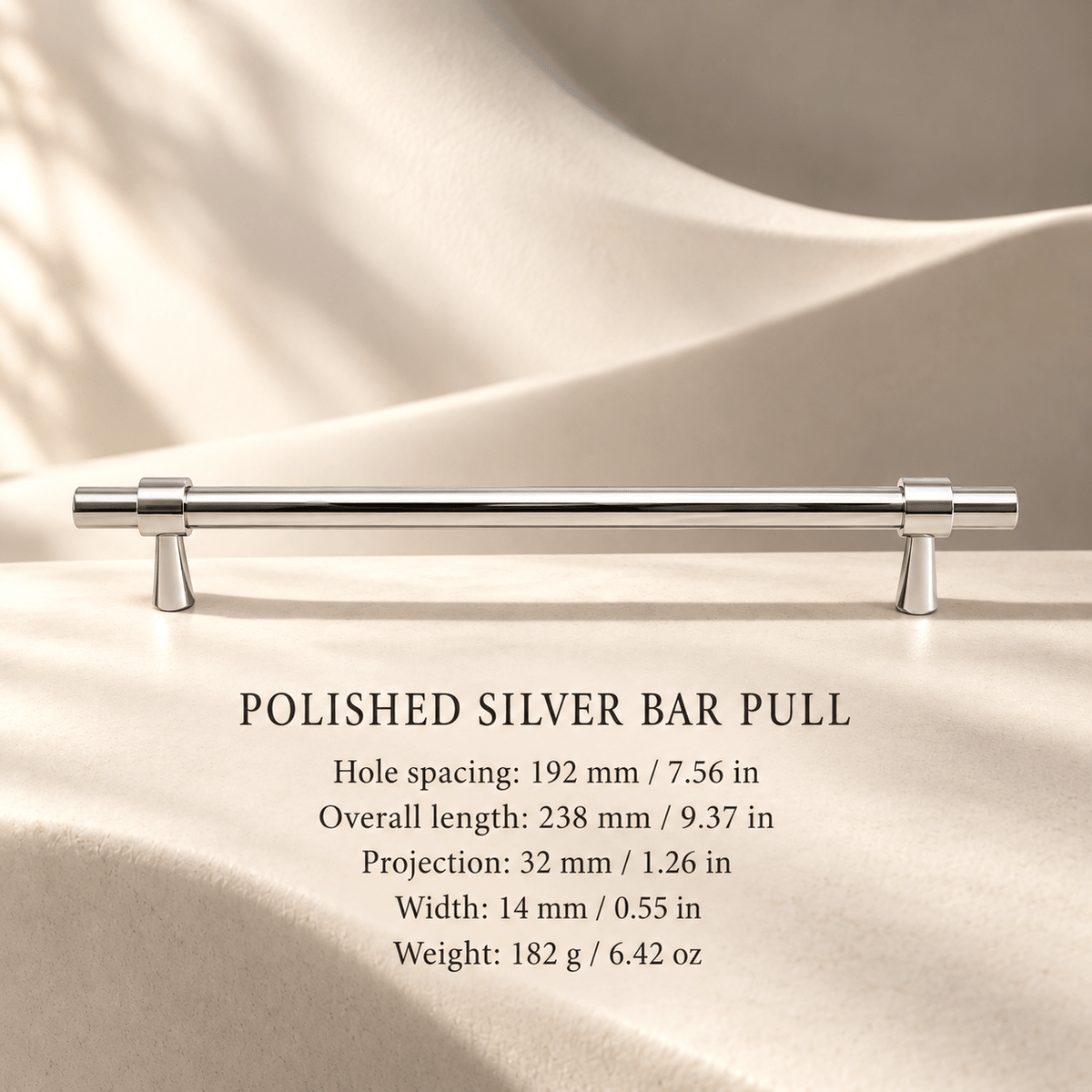 Polished silver solid brass cabinet pull, 192 mm hole spacing, with individual millimeter and inch measurements in an ivory stone studio