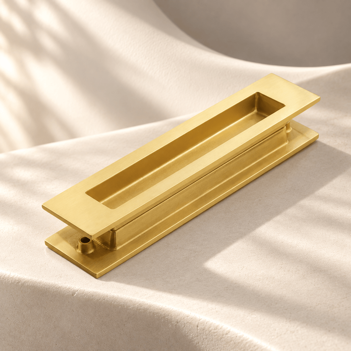 Satin brass rectangular recessed sliding-door pull pair on ivory stone