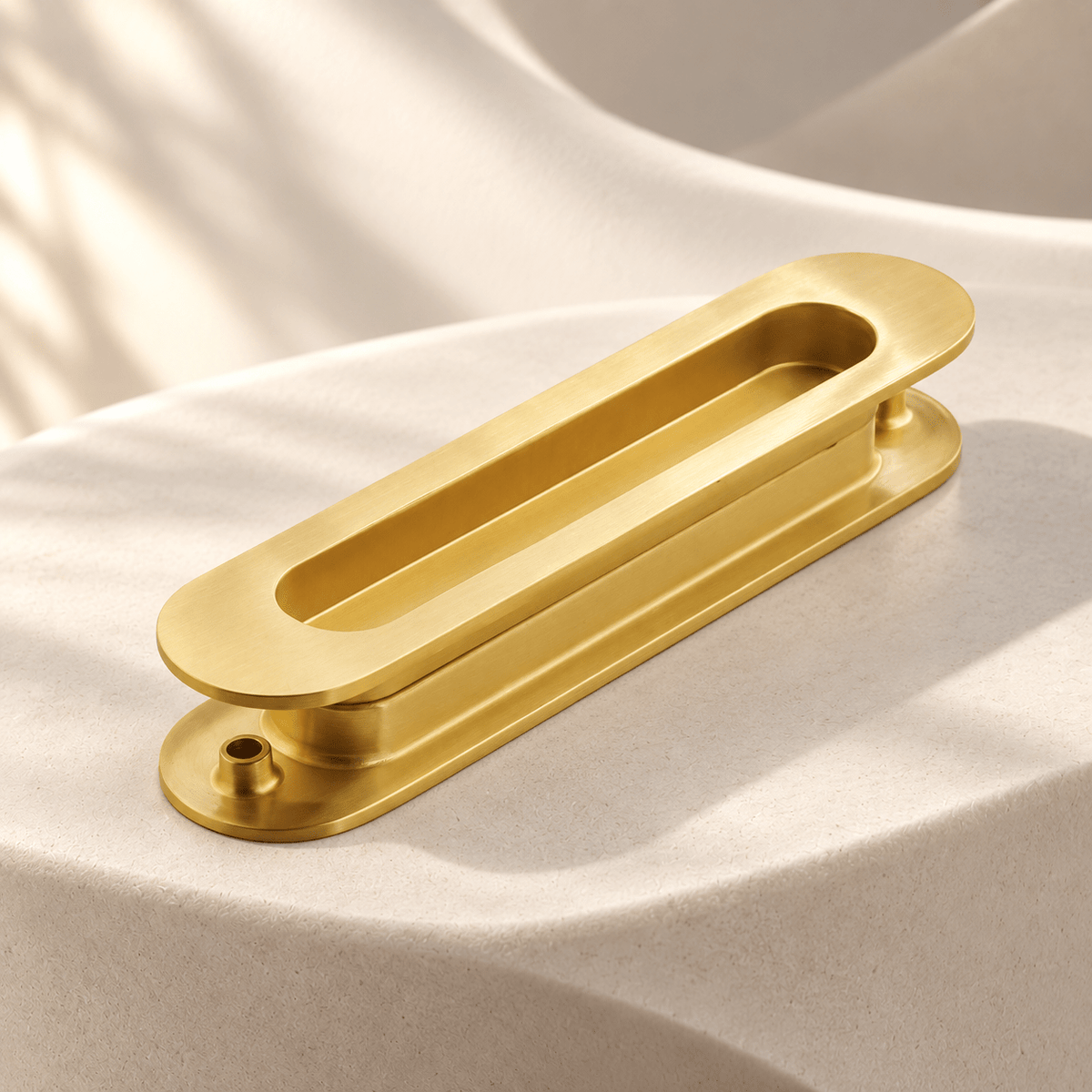 Satin brass rounded recessed sliding-door pull pair on ivory stone