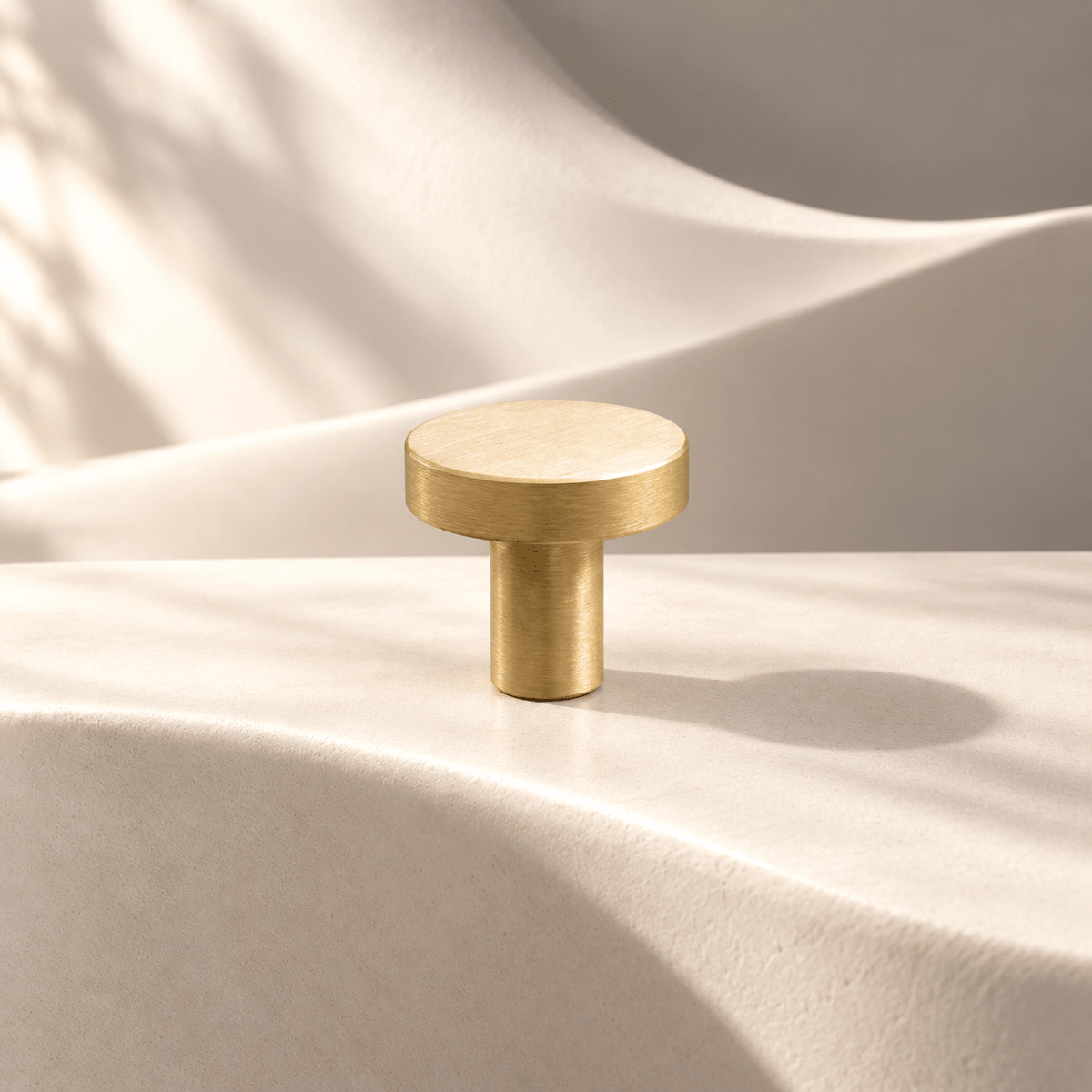 Satin gold disc cabinet knob, 20 mm head diameter and 20 mm projection — warm ivory stone studio