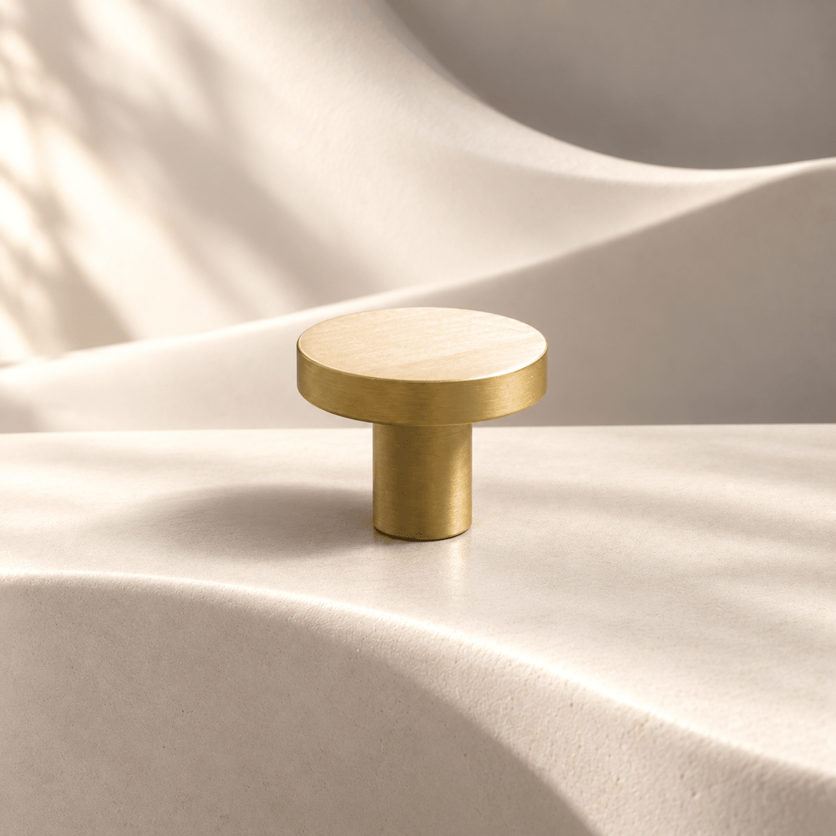 Satin gold disc cabinet knob, 25 mm head diameter and 20 mm projection — warm ivory stone studio