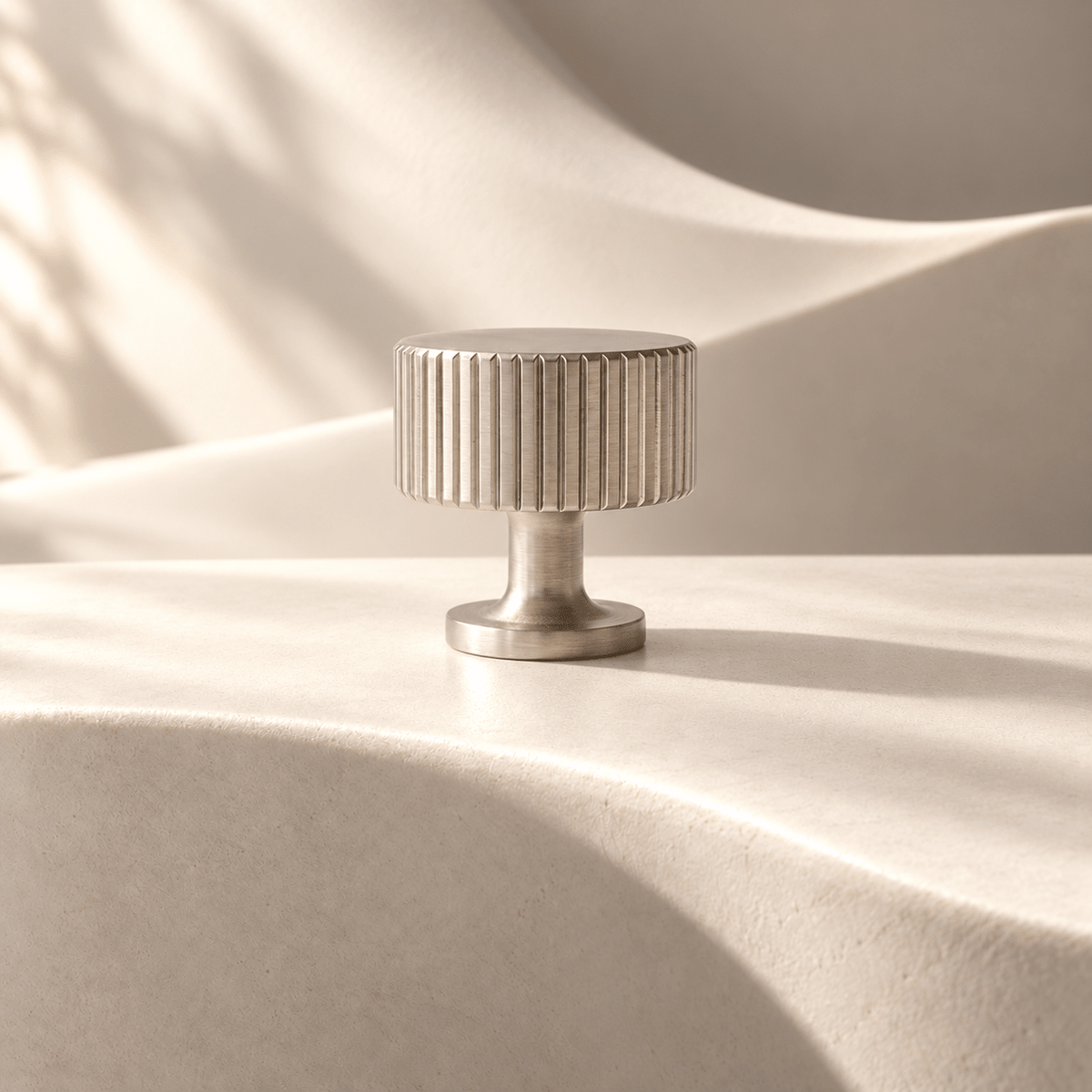 Satin nickel fluted knob, 28 mm head — warm ivory stone studio