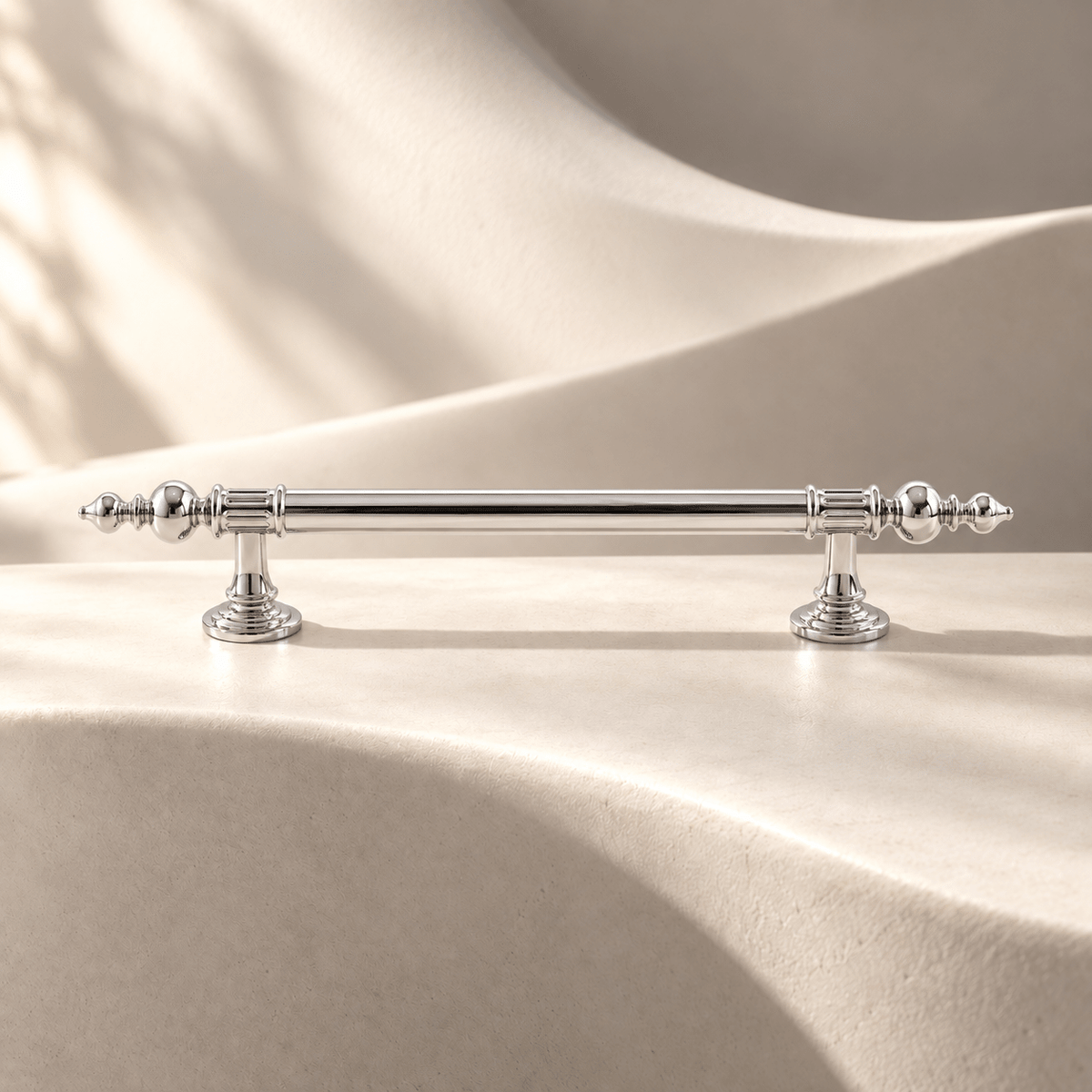 Bright silver 128 mm CTC finial cabinet pull on warm ivory stone