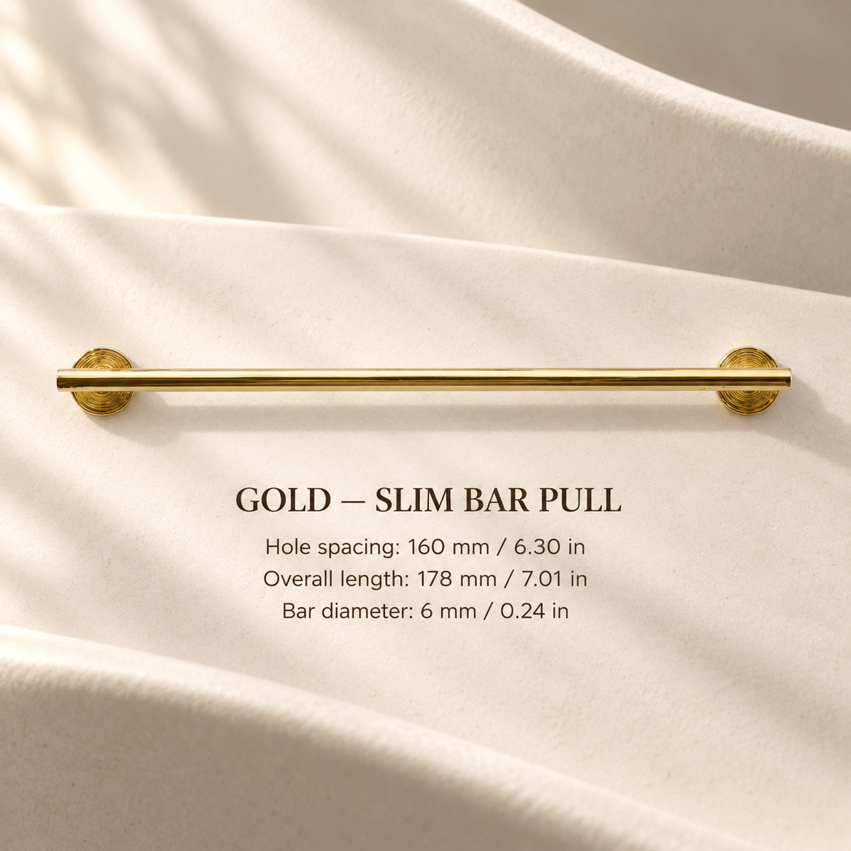 Slim gold cabinet bar pull in ivory studio. Hole spacing: 160 mm / 6.30 in; Overall length: 178 mm / 7.01 in; Bar diameter: 6 mm / 0.24 in