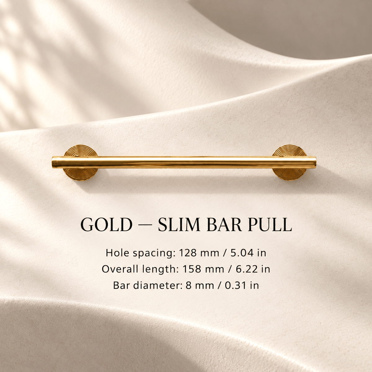 Slim gold cabinet bar pull in ivory studio. Hole spacing: 128 mm / 5.04 in; Overall length: 158 mm / 6.22 in; Bar diameter: 8 mm / 0.31 in