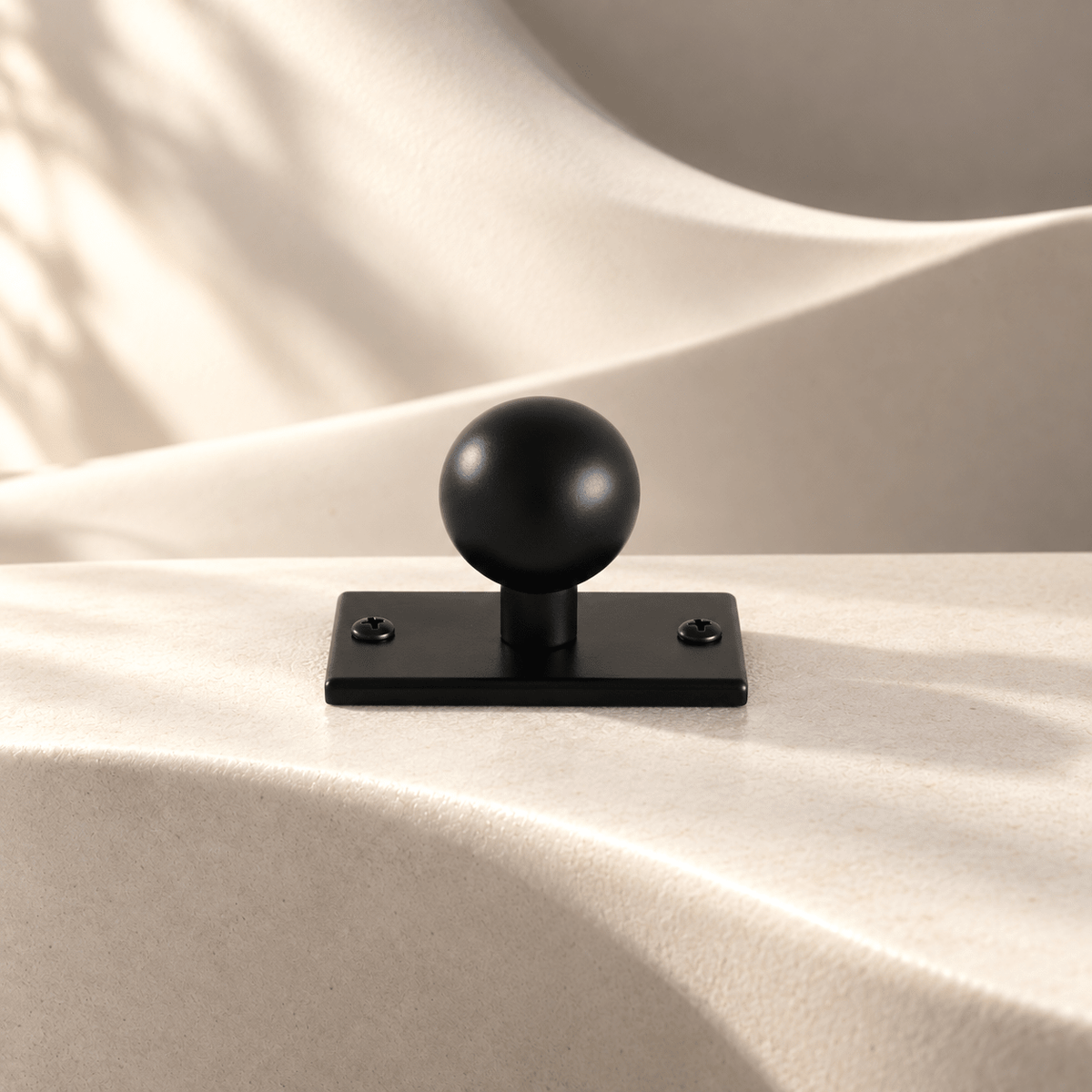 Black 55 mm backplate sphere knob on ivory stone