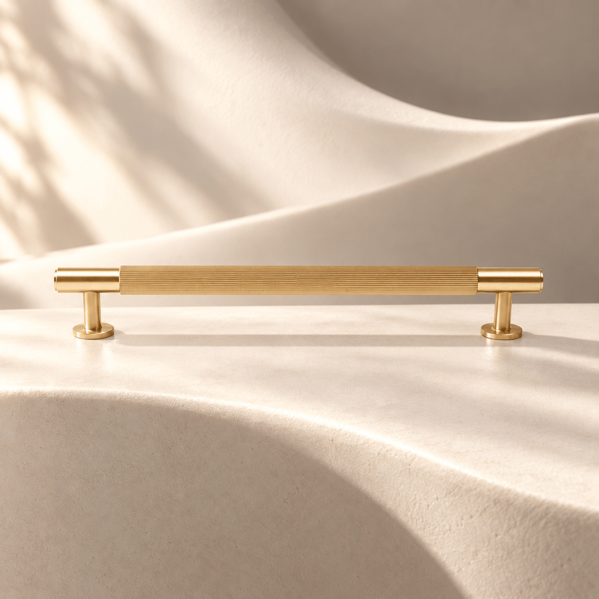 Gold straight-fluted 192 mm center-to-center cabinet pull on warm ivory stone