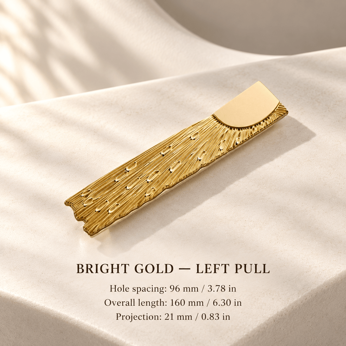Bright gold left textured cabinet pull in ivory studio. Hole spacing: 96 mm / 3.78 in; Overall length: 160 mm / 6.30 in; Projection: 21 mm / 0.83 in.
