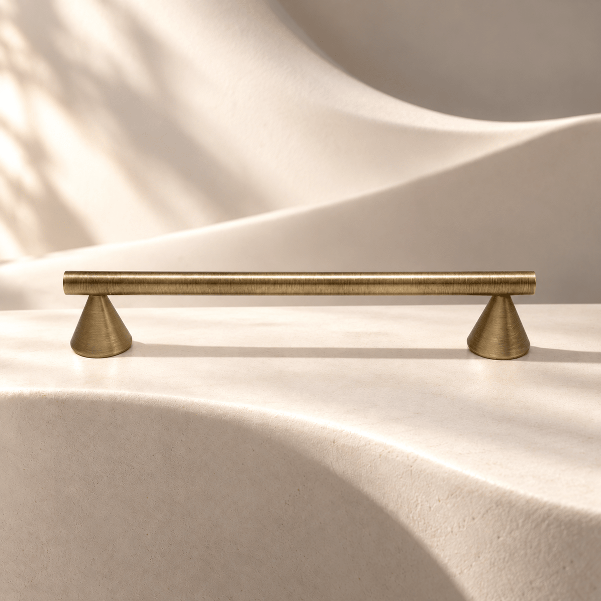 Vintage bronze brass 128 mm center-to-center cabinet pull on warm ivory stone