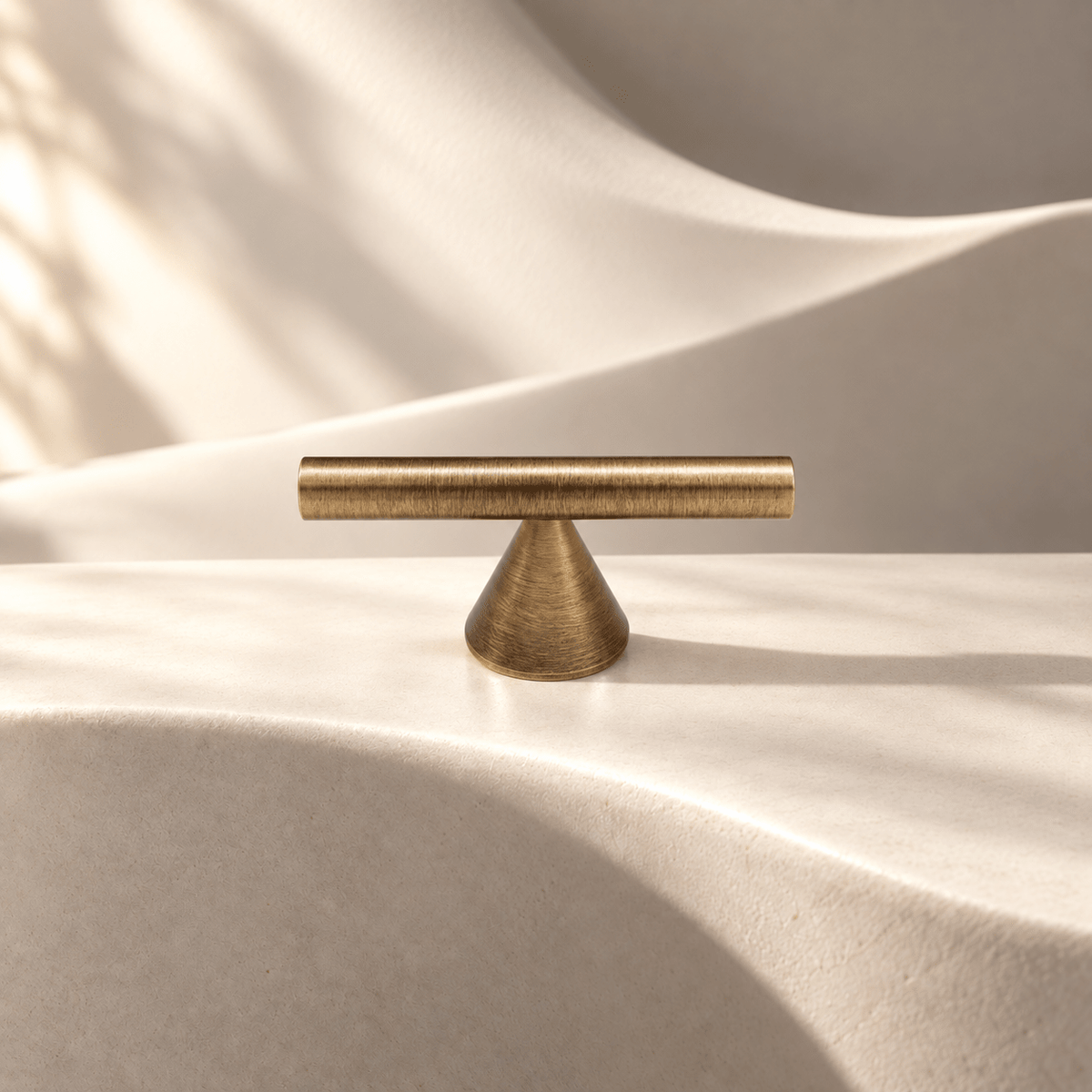Vintage bronze brass T-knob on warm ivory stone