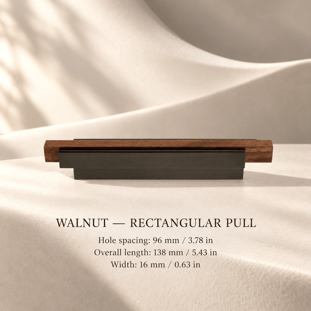 Walnut rectangular cabinet pull in ivory studio. Hole spacing: 96 mm / 3.78 in; Overall length: 138 mm / 5.43 in; Width: 16 mm / 0.63 in