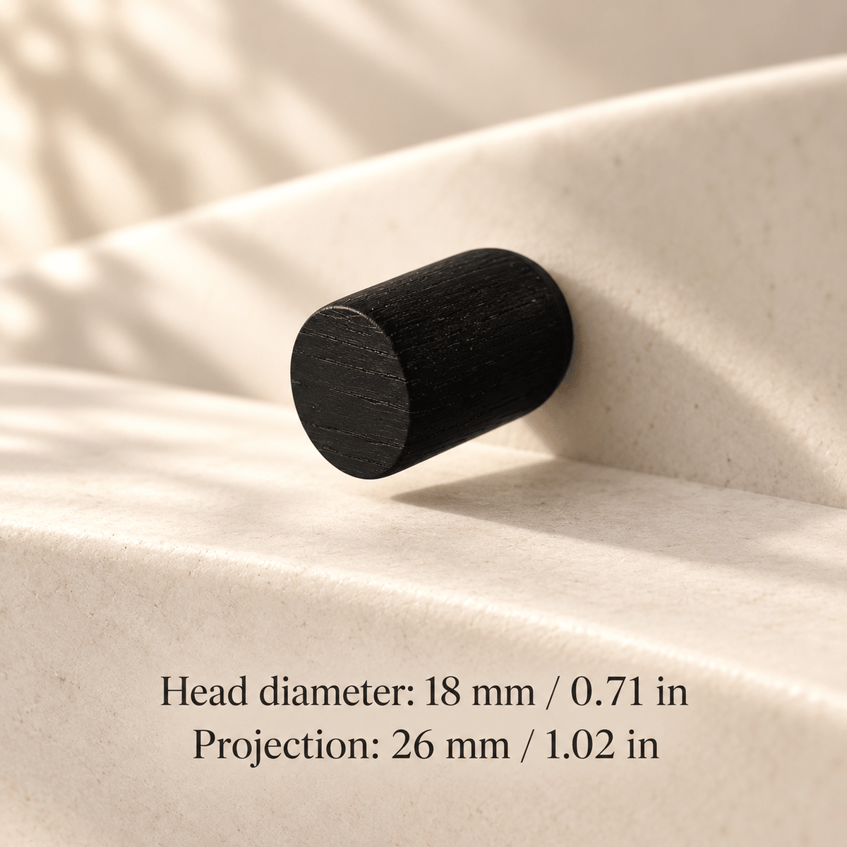 black cabinet knob in ivory studio. Head diameter: 18 mm / 0.71 in; Projection: 26 mm / 1.02 in