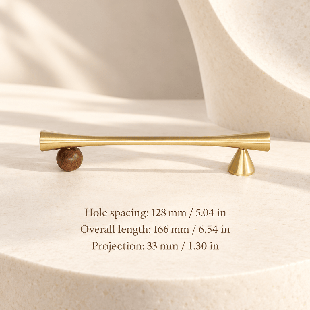 Gold cabinet pull with wooden sphere and cone supports in ivory studio. Hole spacing: 128 mm / 5.04 in; Overall length: 166 mm / 6.54 in; Projection: 33 mm / 1.30 in