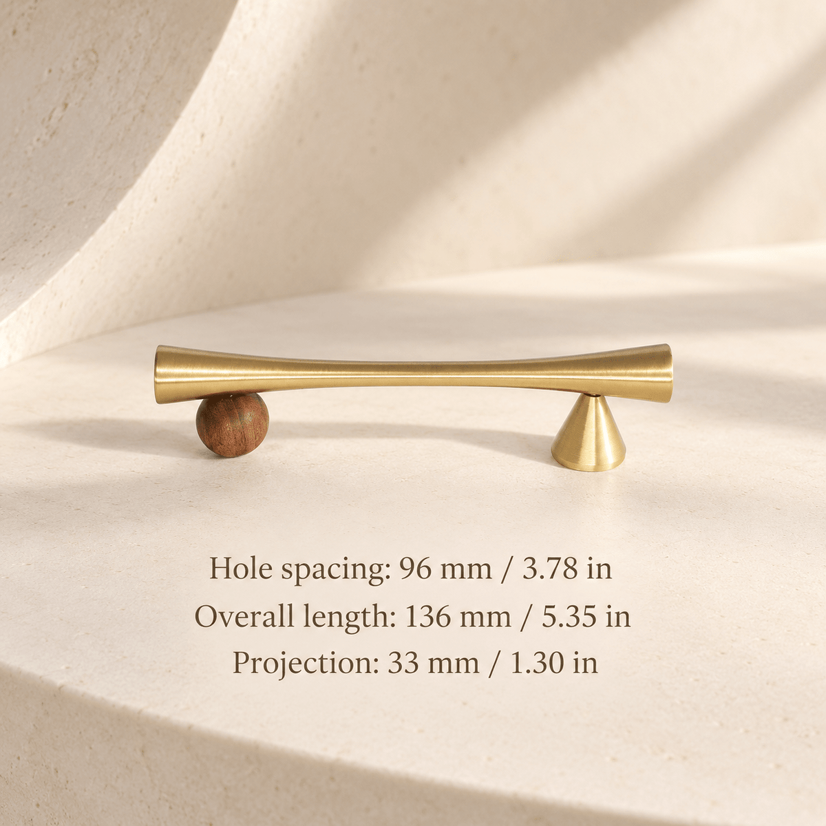 Gold cabinet pull with wooden sphere and cone supports in ivory studio. Hole spacing: 96 mm / 3.78 in; Overall length: 136 mm / 5.35 in; Projection: 33 mm / 1.30 in