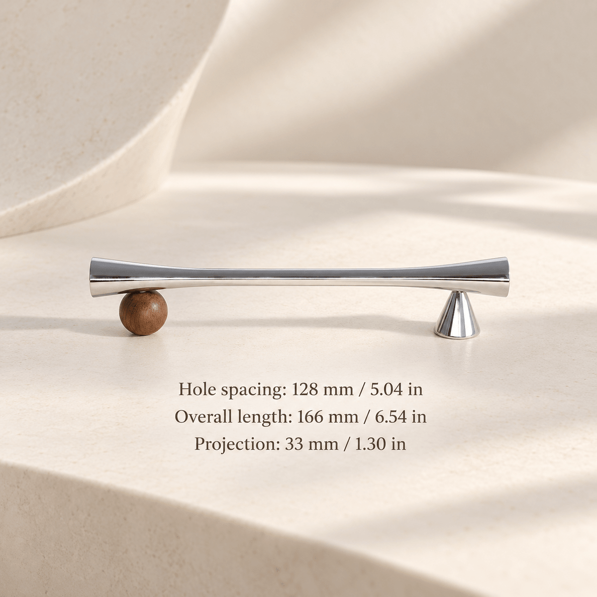 Silver cabinet pull with wooden sphere and cone supports in ivory studio. Hole spacing: 128 mm / 5.04 in; Overall length: 166 mm / 6.54 in; Projection: 33 mm / 1.30 in